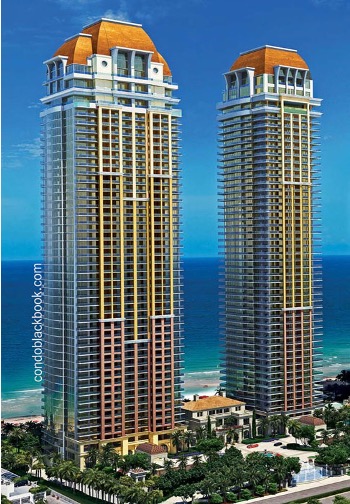 two tall residential buildings by the sea